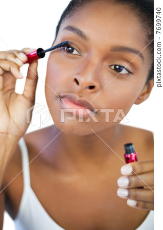 Young woman using mascara for her eyelashes 7699740