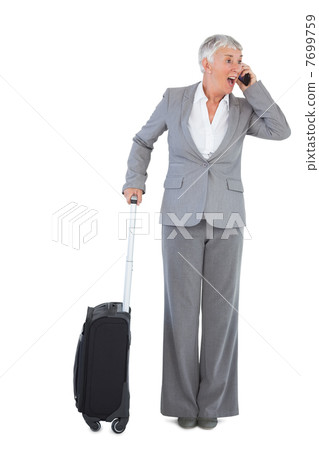 Businesswoman calling and has luggage 7699759