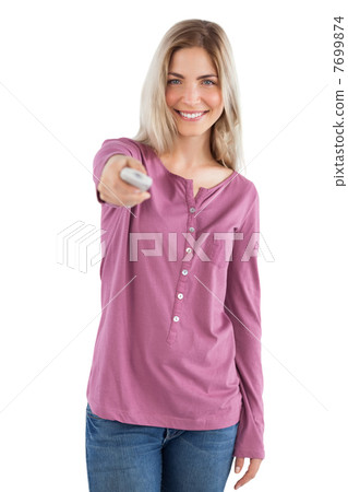 Smiling woman holding remote control Smiling woman holding remote control 7699874