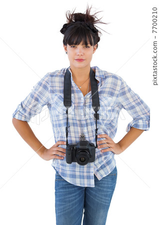 Young woman with camera put hands on her hips Young woman with camera put hands on her hips 7700210