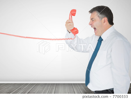 Businessman holding a phone and screaming 7700333