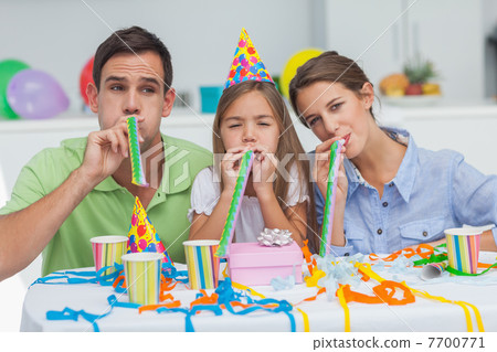 Family playing with party horns Family playing with party horns 7700771