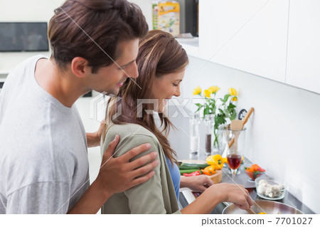 Couple cooking in kitchen 7701027