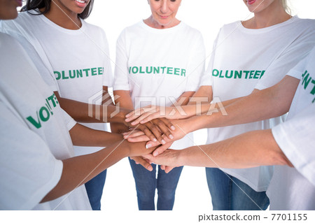 Group of female volunteers with hands together Group of female volunteers with hands together 7701155
