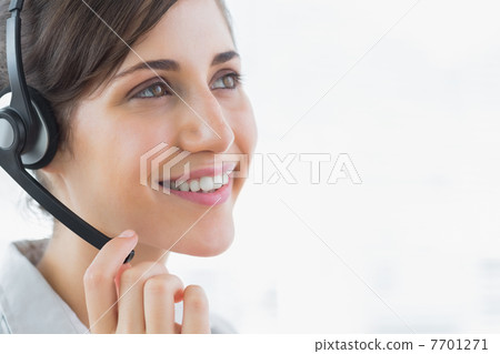Brunette call centre agent smiling 7701271