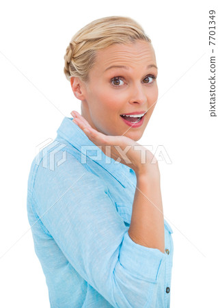 Astonished blonde woman looking at camera 7701349