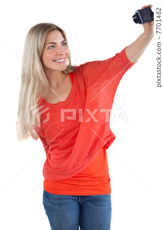 Smiling woman taking picture of herself Smiling woman taking picture of herself 7701482
