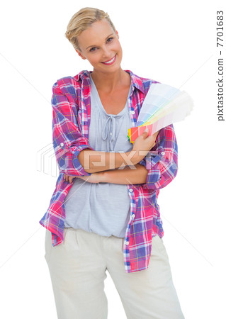 Attractive young woman smiling at camera holding colour charts Attractive young woman smiling at camera holding colour charts 7701683