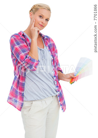 Blonde holding color charts and picking colour Blonde holding color charts and picking colour 7701866