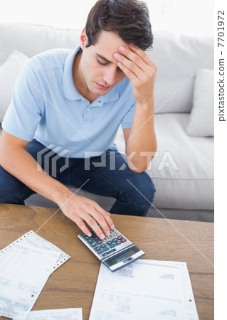 Fearful man doing his accounts 7701972