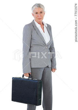 Serious businesswoman holding briefcase 7701974
