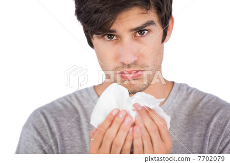 Young man using handkerchief Young man using handkerchief 7702079