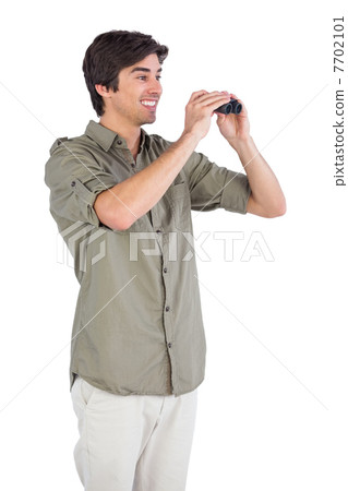 Smiling man using binoculars Smiling man using binoculars 7702101