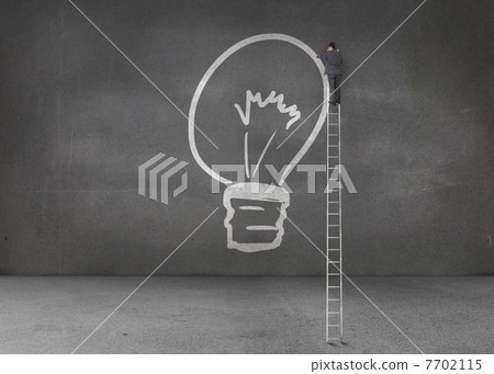 Businessman drawing a light bulb Businessman drawing a light bulb 7702115