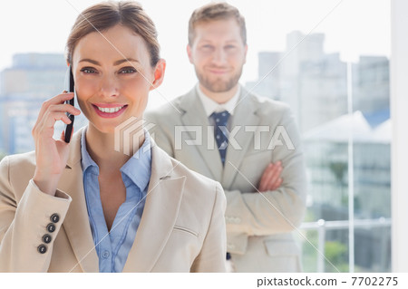 Smiling businesswoman having phone conversation 7702275