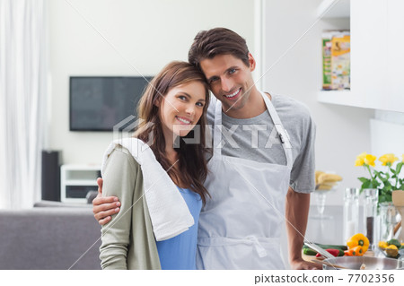 Lovely couple embracing in kitchen 7702356