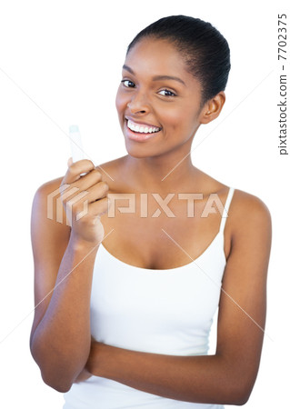 Smiling woman holding her lip balm 7702375