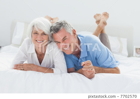 Beautiful couple lying on bed Beautiful couple lying on bed 7702570