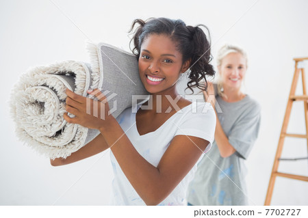 Housemates carrying rolled up rug Housemates carrying rolled up rug 7702727
