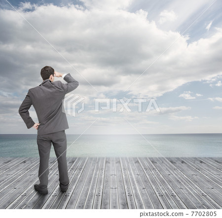 Well dressed businessman standing on wooden boards Well dressed businessman standing on wooden boards 7702805