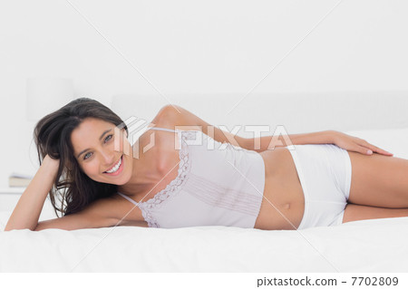 Pretty woman relaxing in bed Pretty woman relaxing in bed 7702809
