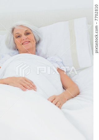 Woman resting in bed Woman resting in bed 7702810
