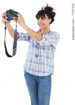 Brunette taking picture with her camera 7702836