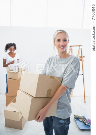 Happy young housemates moving into new home 7703046