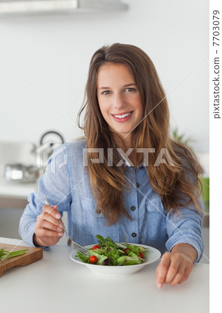 Woman eating a salad 7703079