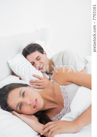 Pretty woman annoyed that her partner snoring 7703161