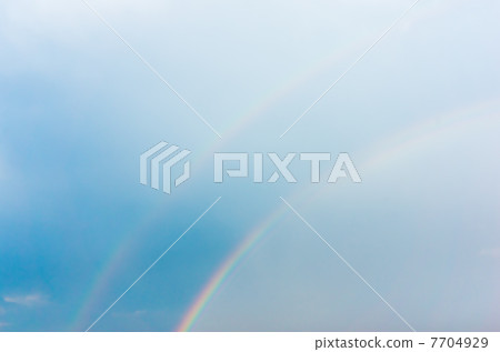 Double rainbow and blue sky 7704929