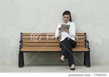 Asian Business woman using a Touch-Pad PC Asian Business woman using a Touch-Pad PC 7706544
