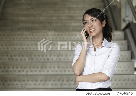Asian Business woman using a Cell Phone 7706546