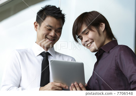 Asian Business people using Touch-pad PC Asian Business people using Touch-pad PC 7706548