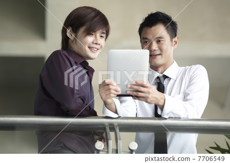Asian Business people using Touch-pad PC Asian Business people using Touch-pad PC 7706549