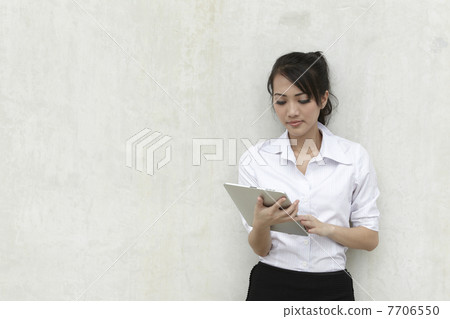 Asian Business woman using a Touch-Pad PC Asian Business woman using a Touch-Pad PC 7706550