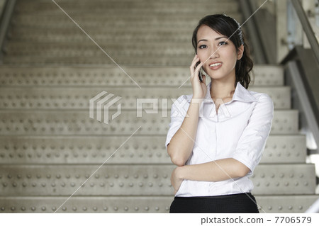 Asian Business woman using a Cell Phone Asian Business woman using a Cell Phone 7706579