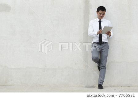 Asian Business man using a Digital Tablet 7706581
