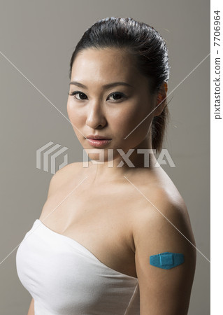 Chinese woman with Bandage on her Arm Chinese woman with Bandage on her Arm 7706964