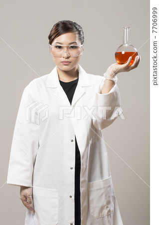 Chinese Woman scientist analyzing a solution. 7706999