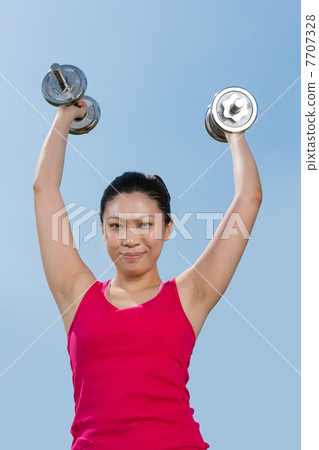 Chinese woman exercising with dumbbells Chinese woman exercising with dumbbells 7707328