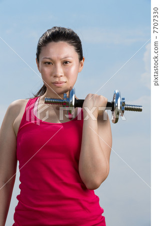 Chinese woman exercising with dumbbells Chinese woman exercising with dumbbells 7707330