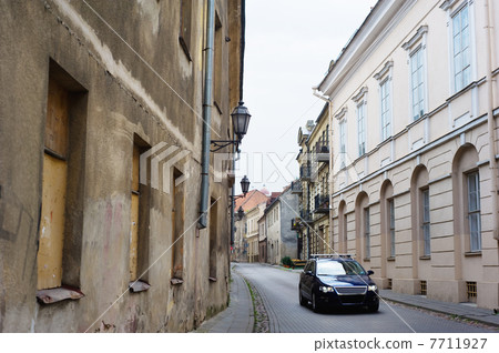 Modern car in narrow paved street 7711927
