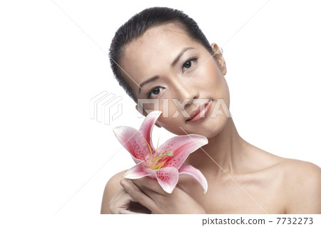 Close-up of a young Asian woman holding a lily Close-up of a young Asian woman holding a lily 7732273