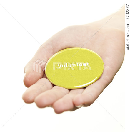 Hand holding volunteer button 7732877