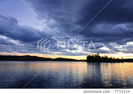 Dramatic sunset at lake 7733224