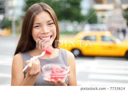 Business woman in New York eating watermelon snack Business woman in New York eating watermelon snack 7733614