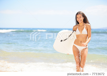 Surfer girl - body surfing beach woman laughing 7733672