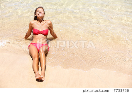 Beach vacation bikini girl sun tanning happy 7733736