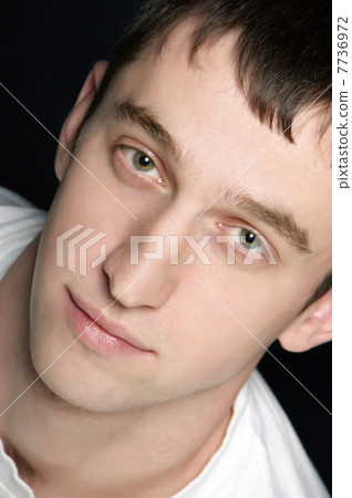 young man - cute guy looking at camera soft key studio shot 7736972